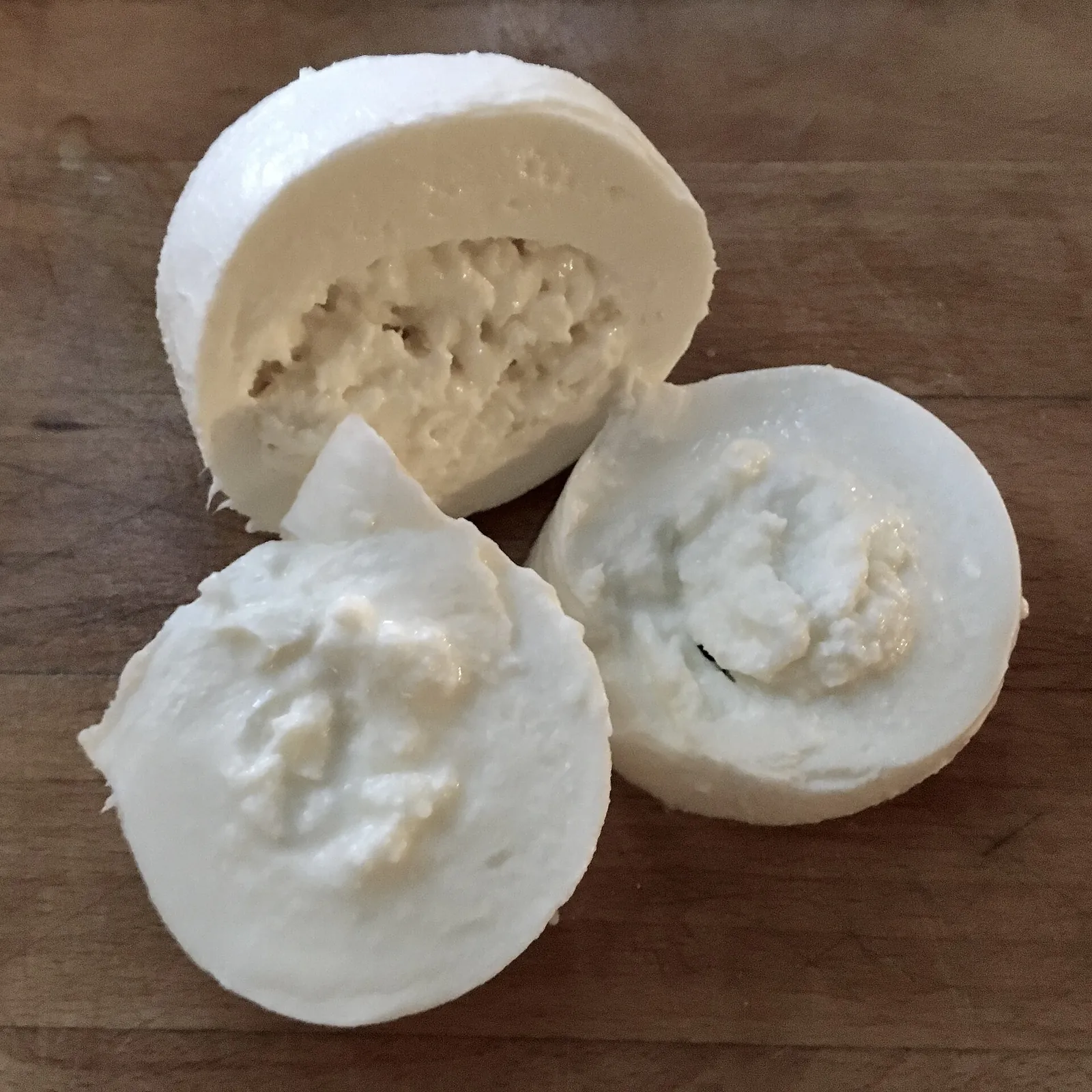 Burrata cut open to show the creamy stracciatella inside its mozzarella shell
