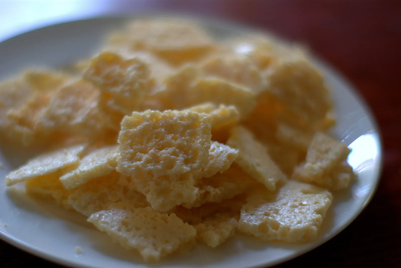 Golden baked cheese crisps on a plate