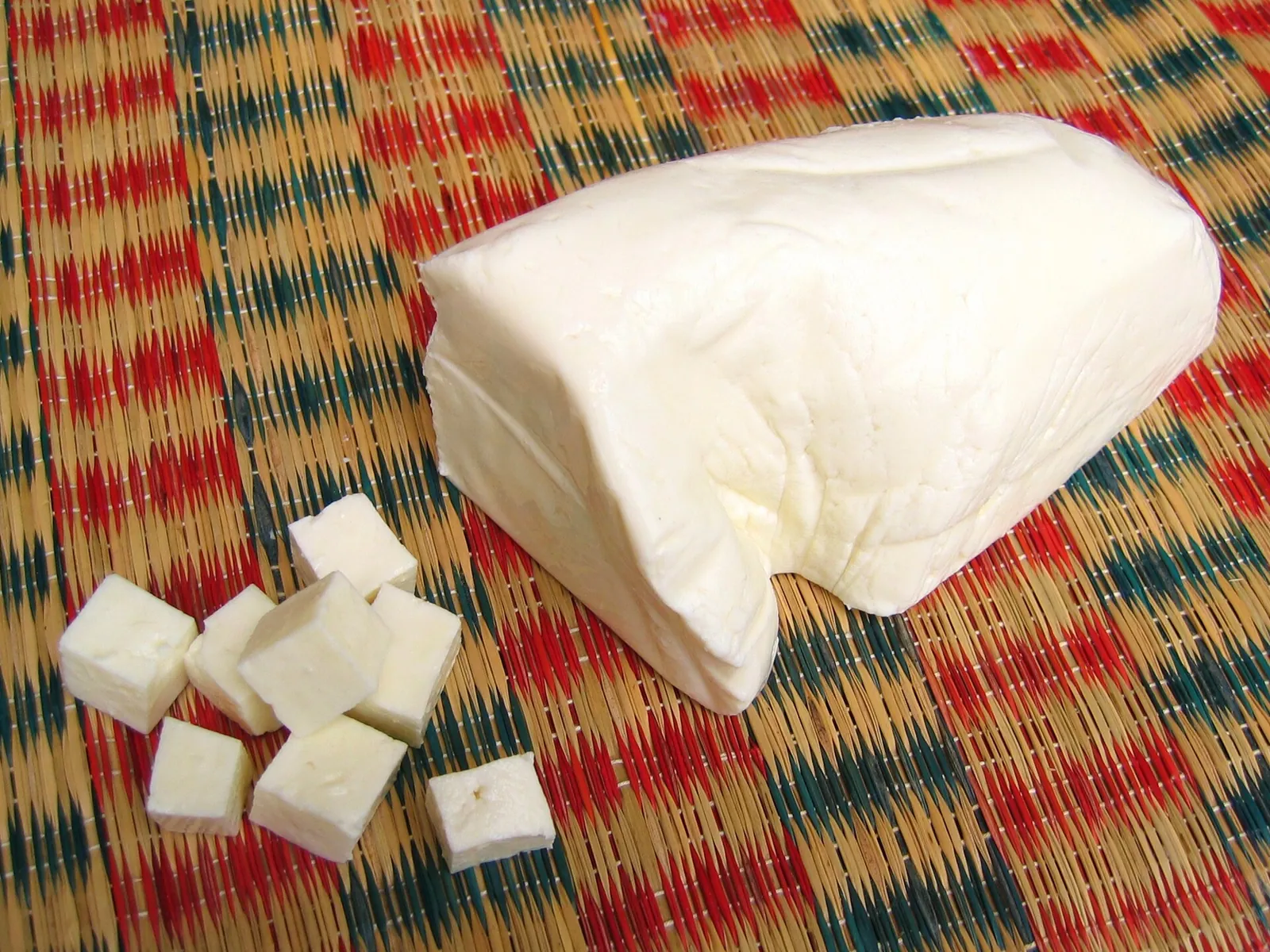 A block of fresh paneer with a few cubes cut from it
