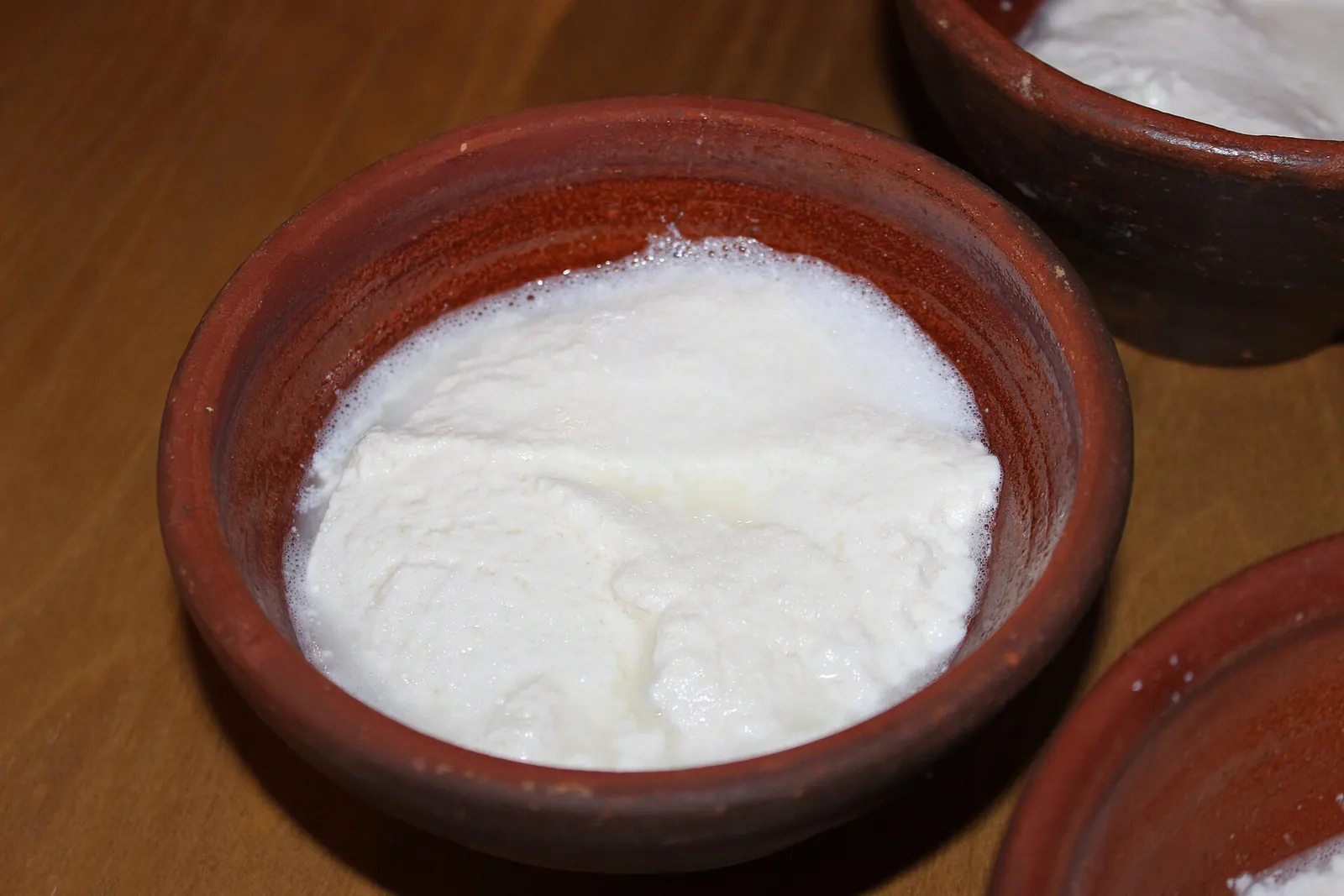 Fresh white ricotta in a terracotta bowl