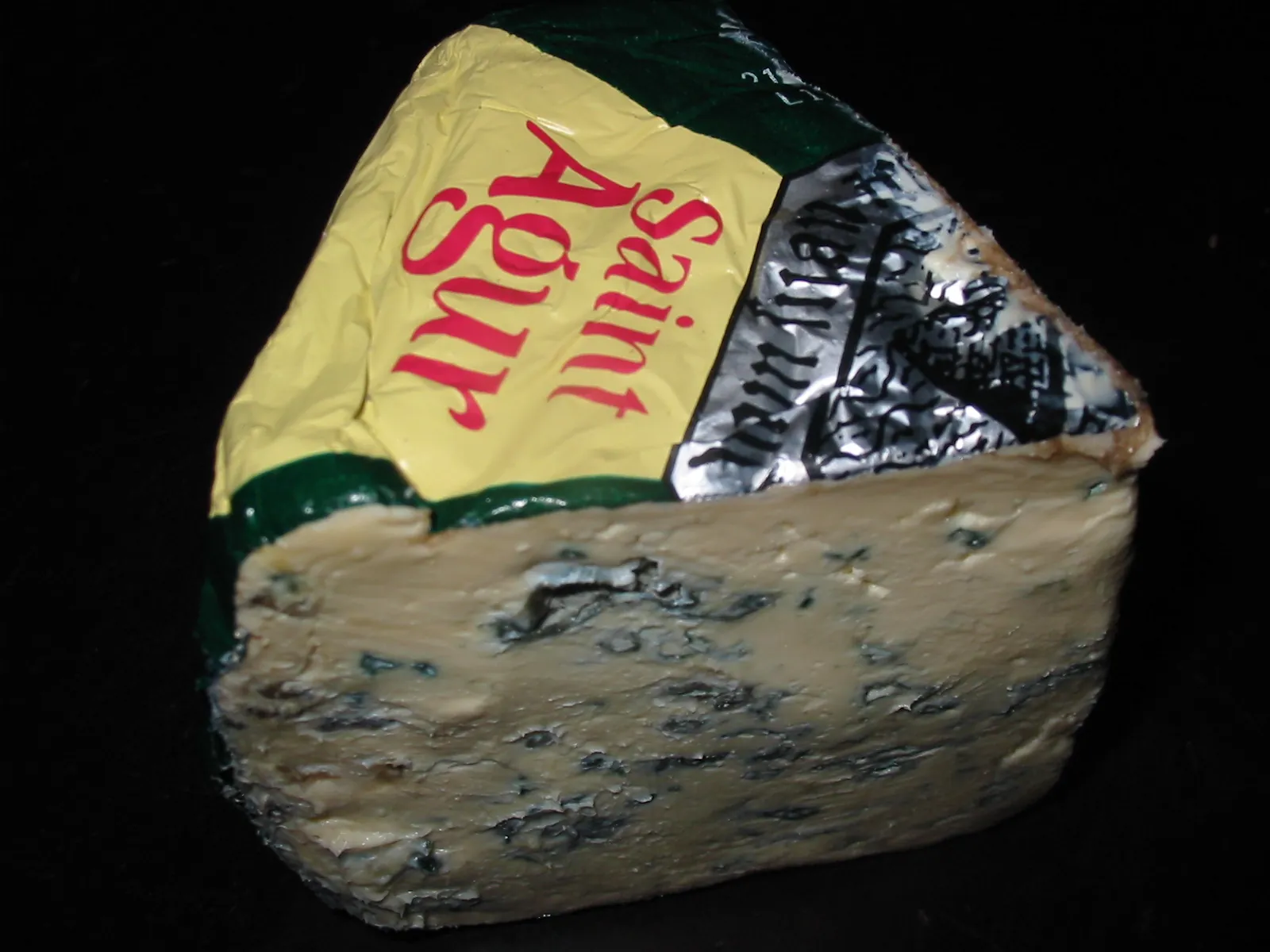 A wedge of Saint Agur blue cheese in its printed foil