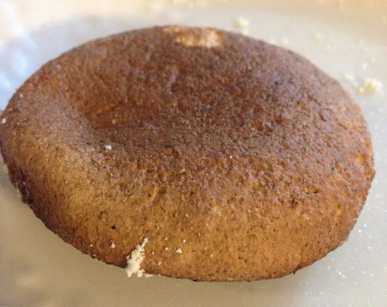 A round Bosnian smoked cheese with a deep brown smoked rind