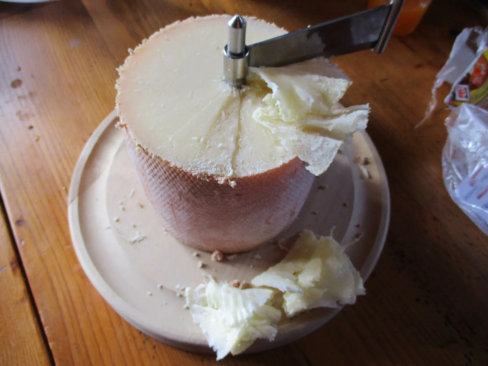 A Tête de Moine on a girolle, the blade shaving thin rosettes from the top of the cheese